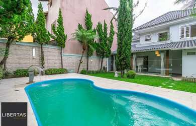 Imagem: A casa possui 3 Dormitórios, 5 Banheiros, 4 Vagas na garagem