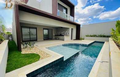 Imagem: A casa possui 4 Dormitórios, 5 Banheiros, 4 Vagas na garagem