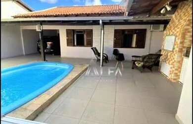 Imagem: A casa possui 3 Dormitórios, 3 Banheiros, 3 Vagas na garagem