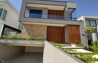 Imagem: A casa possui 4 Dormitórios, 5 Banheiros, 5 Vagas na garagem