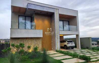 Imagem: A casa possui 4 Dormitórios, 5 Banheiros, 4 Vagas na garagem