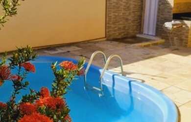 Imagem: A casa possui 3 Dormitórios, 3 Vagas na garagem, Varanda e