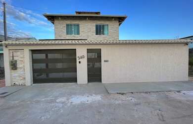 Imagem: A casa possui 4 Dormitórios, 1 Vaga na garagem e está localizado