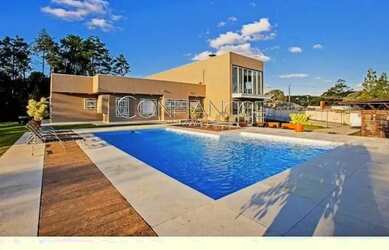 Imagem: A casa possui 5 Dormitórios, 5 Banheiros, 5 Vagas na garagem