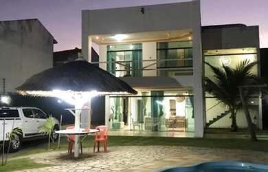 Imagem: A casa possui 5 Dormitórios, 5 Vagas na garagem, Ar-condicionado