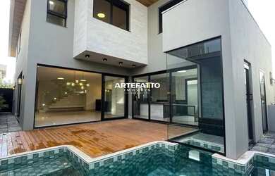 Imagem: A casa possui 4 Dormitórios, 4 Banheiros, 4 Vagas na garagem