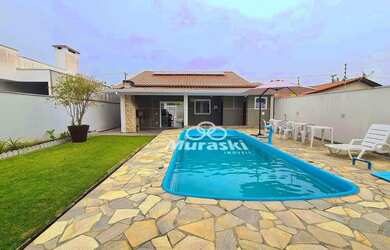 Imagem: A casa possui 4 Dormitórios, 2 Banheiros, 3 Vagas na garagem