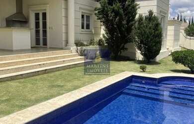 Imagem: A casa possui 3 Dormitórios, 5 Banheiros, 4 Vagas na garagem