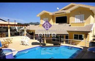 Imagem: A casa em condomínio possui 5 Dormitórios, 5 Suítes, 7 Banheiros